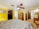 Comfortable main bedroom featuring a ceiling fan, closet, and en-suite bathroom, offering a private retreat at 239 Rue De Fontaine, Tavares, FL 32778