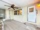 Spacious sunroom featuring an exit door, a sliding glass door and a neutral color carpet at 239 Rue De Fontaine, Tavares, FL 32778