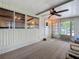 Enclosed sunroom featuring multiple windows, neutral color carpet, and a ceiling fan at 239 Rue De Fontaine, Tavares, FL 32778