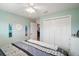 Comfortable bedroom featuring a ceiling fan, closet space, and decor at 2448 Bachman Path, The Villages, FL 32162
