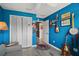 Bedroom featuring musical instruments, a closet, and blue walls at 2448 Bachman Path, The Villages, FL 32162