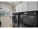 Bright laundry room with modern washer and dryer at 2448 Bachman Path, The Villages, FL 32162