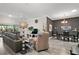 Bright living room that leads to the dining room with gray accent wall and hardwood floors at 2448 Bachman Path, The Villages, FL 32162
