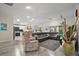 Inviting living room with hardwood floors, an open layout, and seamless flow to the kitchen and dining area at 2448 Bachman Path, The Villages, FL 32162