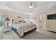 The main bedroom features vaulted ceilings, carpet floors, and an open view to the ensuite bathroom at 2448 Bachman Path, The Villages, FL 32162