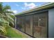 View of a screened patio with sliding doors, showcasing an outdoor recreation area with foosball table at 2448 Bachman Path, The Villages, FL 32162