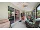 Bright sunroom with sliding glass doors, a TV, and comfortable seating at 2448 Bachman Path, The Villages, FL 32162