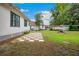 Spacious backyard featuring a unique checkerboard patio, greenery, and surrounding trees at 263 Ne 1St St, Webster, FL 33597