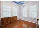 Bedroom featuring hardwood floors, windows, and unique cloud-painted ceiling at 263 Ne 1St St, Webster, FL 33597