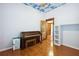 Bedroom featuring hardwood floors, a piano, a closet, and natural light at 263 Ne 1St St, Webster, FL 33597