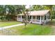 Charming home with a inviting porch and well-maintained lawn surrounded by a fence at 263 Ne 1St St, Webster, FL 33597