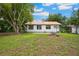 Back exterior of the house with charming details and ample backyard space at 263 Ne 1St St, Webster, FL 33597