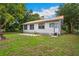 View of the back of the house showing windows, door and patio area at 263 Ne 1St St, Webster, FL 33597