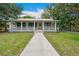 Inviting home with a covered front porch, walkway and charming architectural details at 263 Ne 1St St, Webster, FL 33597