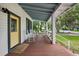 Inviting front porch with a yellow door, chairs, and a cozy welcome at 263 Ne 1St St, Webster, FL 33597