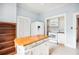 Spacious kitchen with stainless steel appliances, a butcher block kitchen island, and ample cabinet space at 263 Ne 1St St, Webster, FL 33597
