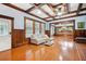 Elegant living room boasts wood paneling, coffered ceilings, and bright windows at 263 Ne 1St St, Webster, FL 33597