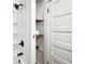 A bright shower with modern fixtures, convenient shelves, and a white door at 263 Ne 1St St, Webster, FL 33597