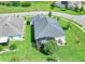 Aerial view of a home highlighting a screened lanai, patio area, and well-manicured lawn at 26601 Otter Creek Ln, Leesburg, FL 34748