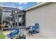 Private backyard featuring an outdoor fire pit, Adirondack chairs, and an attached screened lanai at 26601 Otter Creek Ln, Leesburg, FL 34748