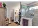 Stylish bathroom featuring a glass-enclosed shower, neutral tiling, and modern fixtures for a spa-like experience at 26601 Otter Creek Ln, Leesburg, FL 34748