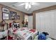 Cozy bedroom with playful decor, comfortable bed, and closet space offering a welcoming atmosphere at 26601 Otter Creek Ln, Leesburg, FL 34748