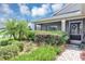 Inviting front porch with a seating area, complemented by lush landscaping and a decorative wreath at 26601 Otter Creek Ln, Leesburg, FL 34748