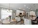 Bright kitchen features white cabinets, granite countertops, stainless steel appliances, and a cozy dining area at 26601 Otter Creek Ln, Leesburg, FL 34748