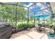 Relaxing screened lanai area with outdoor seating, lush greenery, and a sunny atmosphere at 26601 Otter Creek Ln, Leesburg, FL 34748