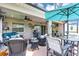 Charming covered patio with wicker furniture, dining area, and seamless indoor-outdoor living at 26601 Otter Creek Ln, Leesburg, FL 34748