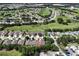 Aerial view of the community with mature trees and the home outlined in red at 26917 White Plains Way, Leesburg, FL 34748