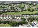 Birds eye view of cozy townhomes near a large golf course with a pond, offering beautiful serene views at 26917 White Plains Way, Leesburg, FL 34748