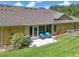 Backyard featuring a patio area with comfortable seating and well-kept lawn at 26917 White Plains Way, Leesburg, FL 34748