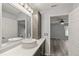 Bathroom with a modern vessel sink, elegant vanity, and access to the bright and airy main bedroom at 26917 White Plains Way, Leesburg, FL 34748
