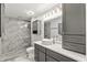Modern bathroom featuring a walk-in shower, gray cabinets, and white countertop at 26917 White Plains Way, Leesburg, FL 34748