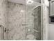Bathroom with marble shower and safety bar, modern fixtures, and a luxurious, spa-like atmosphere at 26917 White Plains Way, Leesburg, FL 34748