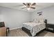 Comfortable bedroom featuring a ceiling fan, a bed, and light gray walls at 26917 White Plains Way, Leesburg, FL 34748