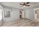 Spacious bedroom featuring hardwood floors, a ceiling fan, and neutral wall color at 26917 White Plains Way, Leesburg, FL 34748