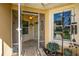 Inviting screened-in front entrance with ceiling fan, decorative plants, and plenty of light at 26917 White Plains Way, Leesburg, FL 34748