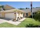 Charming home exterior with a two-car garage, well-maintained lawn, and nautical decorations at 26917 White Plains Way, Leesburg, FL 34748