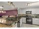 Modern kitchen featuring granite countertops, a stylish backsplash, and stainless steel appliances for a sleek look at 26917 White Plains Way, Leesburg, FL 34748