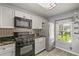Updated kitchen boasts a gas range, stainless steel refrigerator and appliances, and ample cabinet space at 26917 White Plains Way, Leesburg, FL 34748