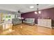 Bright living room with beautiful hardwood floors, skylight, and comfortable seating at 26917 White Plains Way, Leesburg, FL 34748