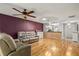 Cozy living room with hardwood floors, skylight, comfortable seating, and an open concept at 26917 White Plains Way, Leesburg, FL 34748