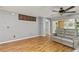 Cozy living room featuring hardwood floors, a ceiling fan, and neutral wall color at 26917 White Plains Way, Leesburg, FL 34748