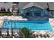Large community pool with clear blue water, spacious deck, and clubhouse in the background at 26917 White Plains Way, Leesburg, FL 34748