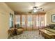 Relaxing sunroom with tile flooring and natural light, perfect for enjoying the outdoors from the comfort of home at 26917 White Plains Way, Leesburg, FL 34748