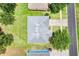 Aerial view of the house featuring a well-maintained roof, a lush green lawn, and a driveway at 2745 Shearwater St, Clermont, FL 34711