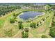 Scenic aerial view of a community lake surrounded by walking paths and lush greenery at 2745 Shearwater St, Clermont, FL 34711