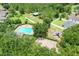Overhead view of community playground with a blue pool and plentiful parking surrounded by trees at 2745 Shearwater St, Clermont, FL 34711
